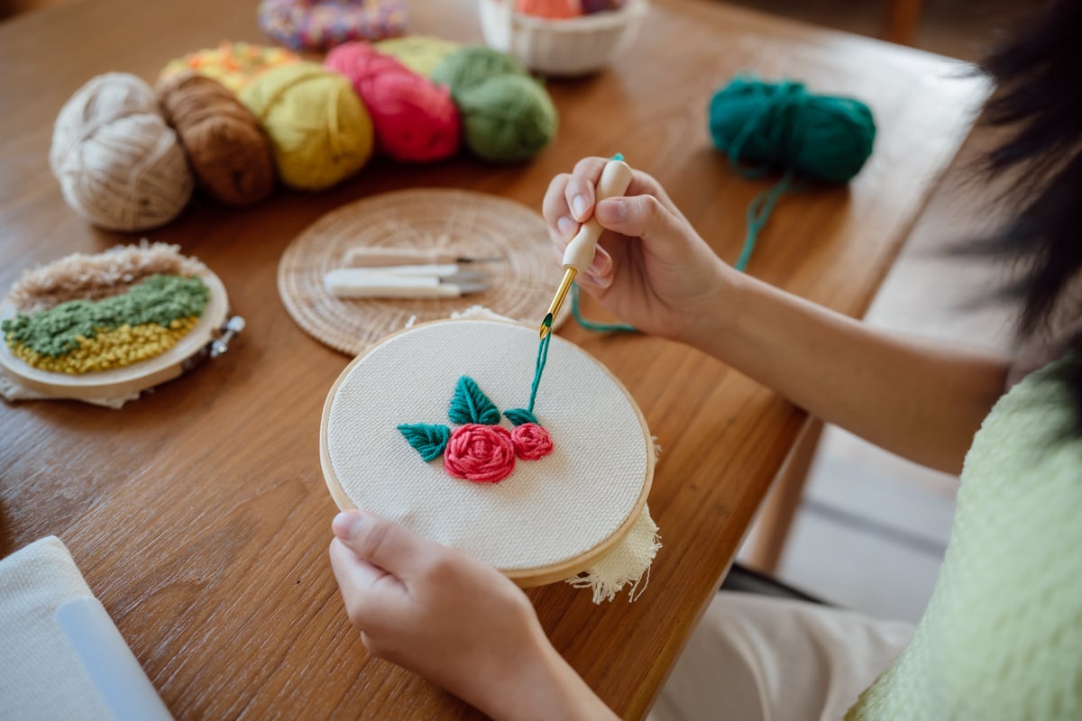 Punch Needle. Asian Woman Making Handmade Hobby Knitting in Stud